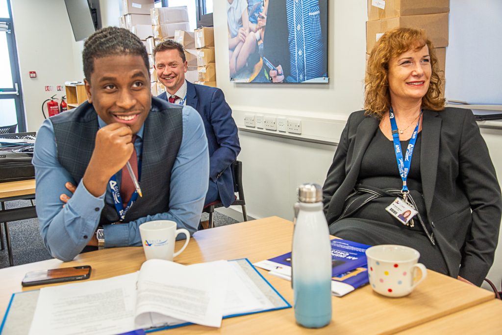 Delta colleagues sat around a table attending training