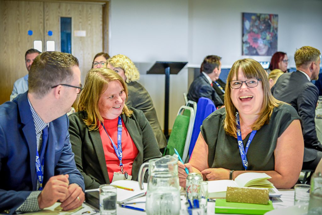 Delta colleagues chatting around a table